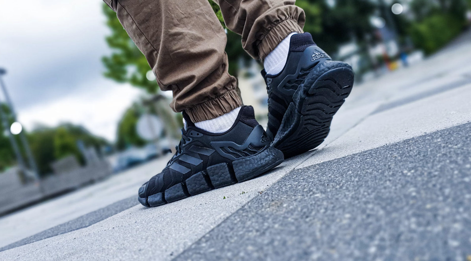 A close-up shot of On Cloud running shoes with CloudTec® sole technology on a running track, showcasing its lightweight and sleek design.