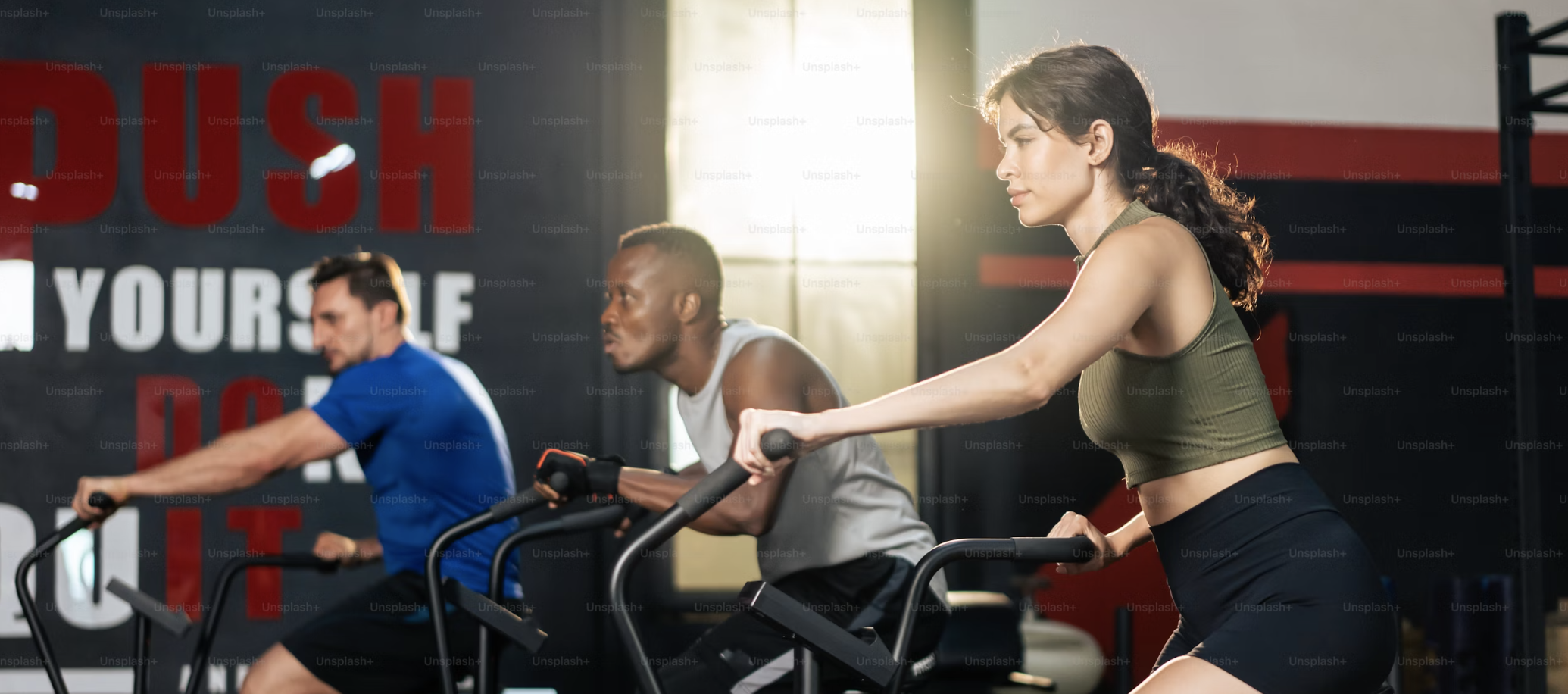 Diverse members enjoying a workout at a bright Planet Fitness gym, symbolizing affordable fitness
