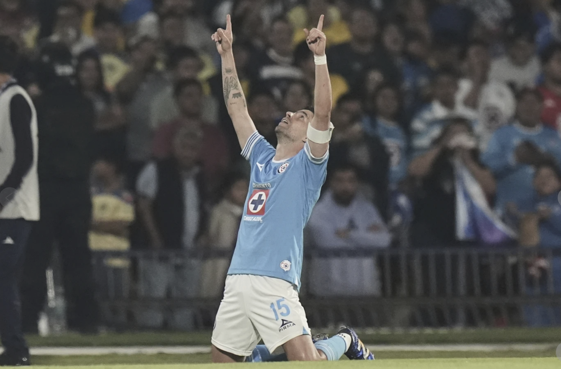 Cruz Azul player celebrating a goal in a Liga MX match.