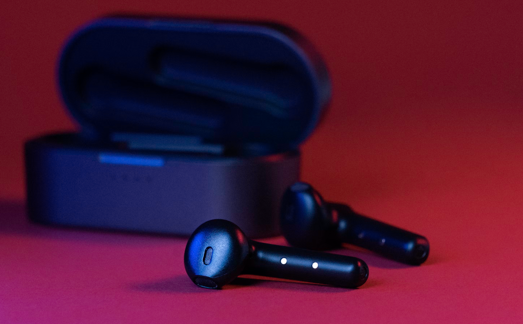 Premium wireless earbuds with a metallic white design surrounded by soundwave abstract visuals.