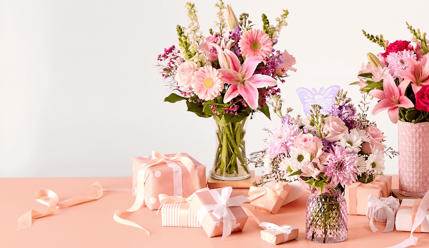 Elegant Mother’s Day bouquet with roses, lilies, and greenery in a decorative vase.